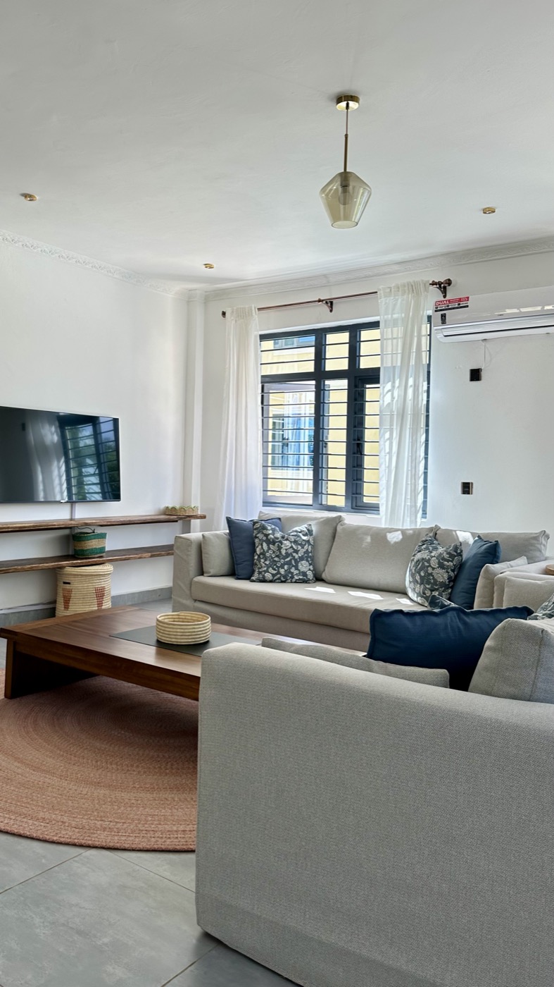 Living room with linen sofas and TV