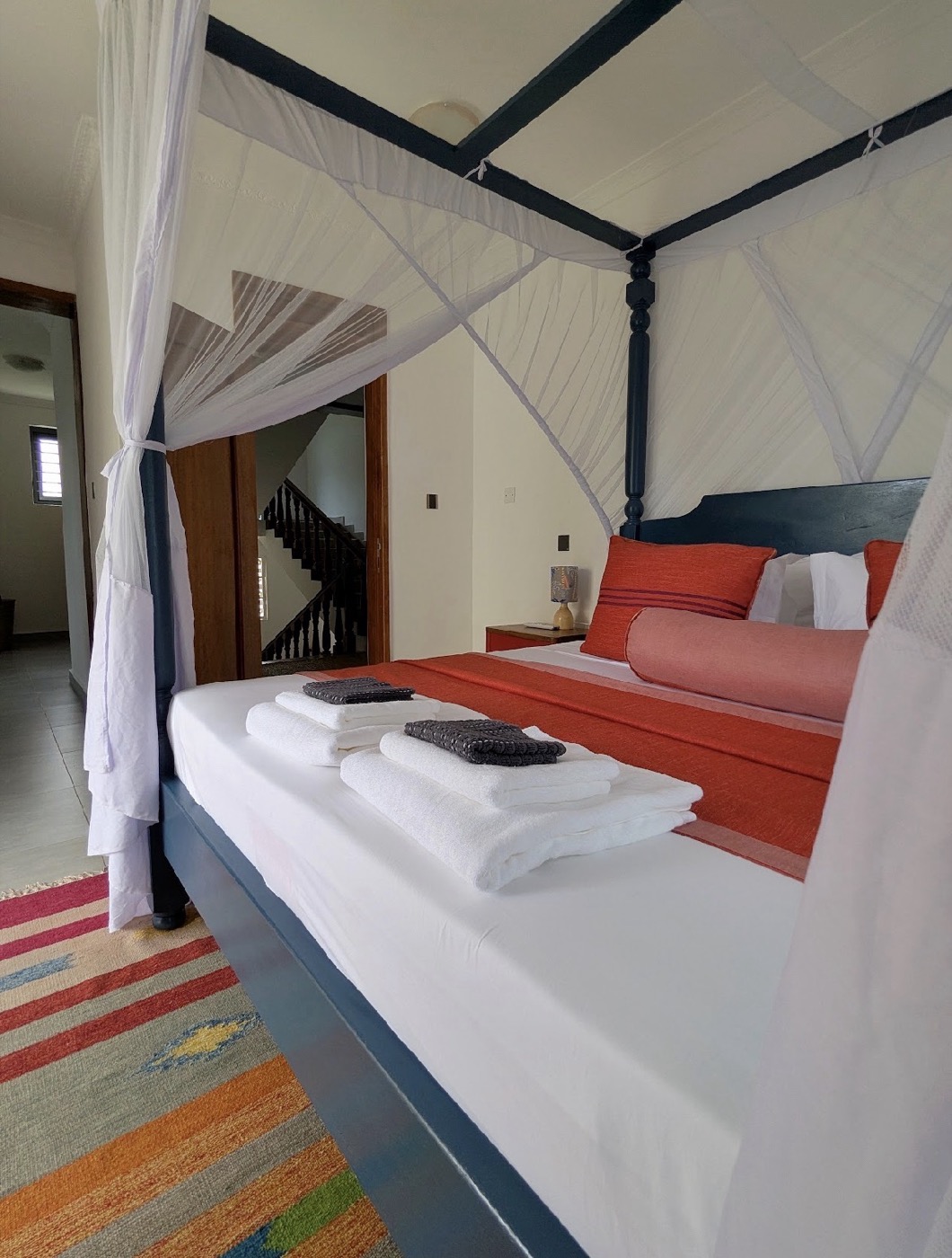 The blue upper-floor king bedroom